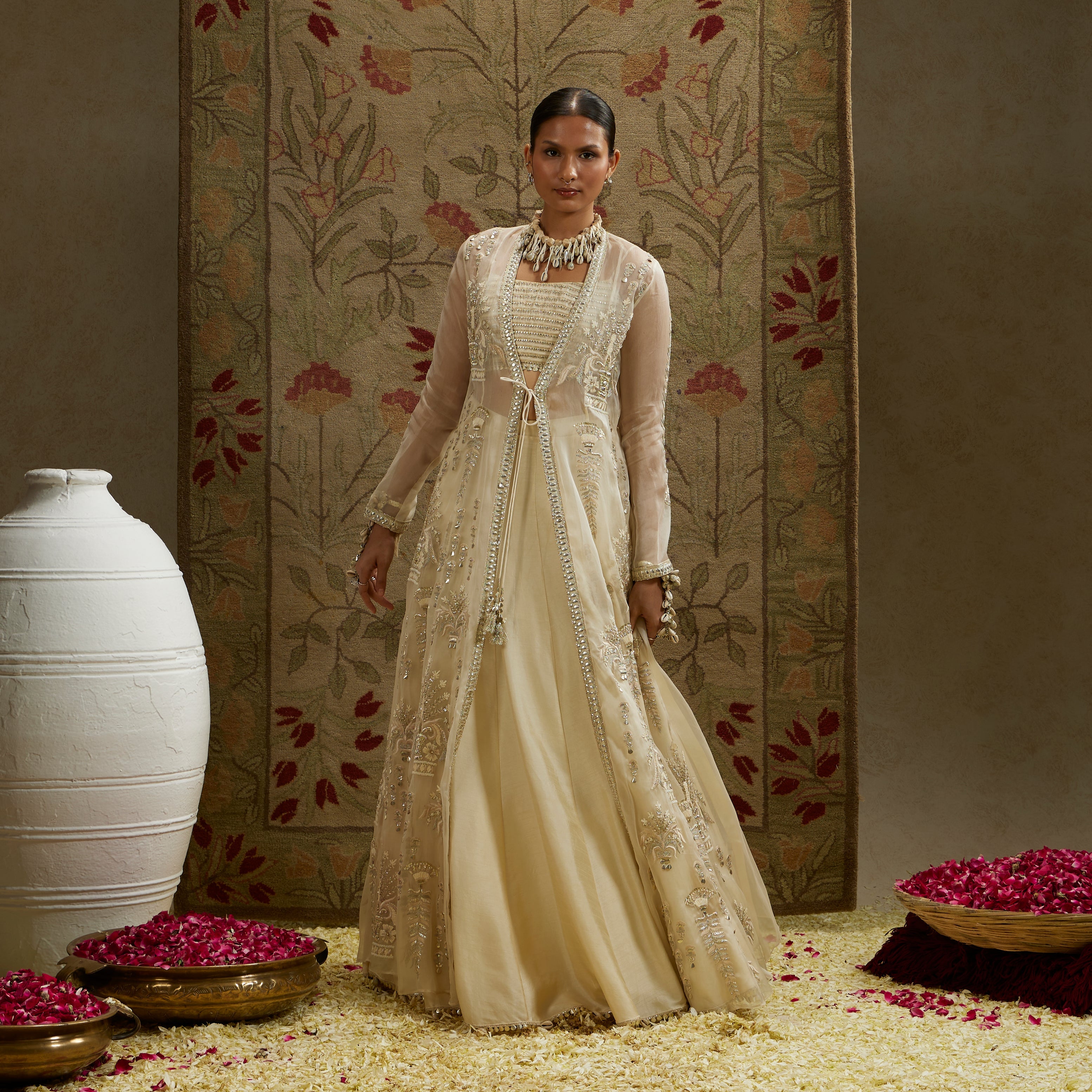 MEHEK: MAGNOLIA ORGANZA EMBELLISHED JACKET PAIRED WITH METAL BUSTIER AND LEHENGA