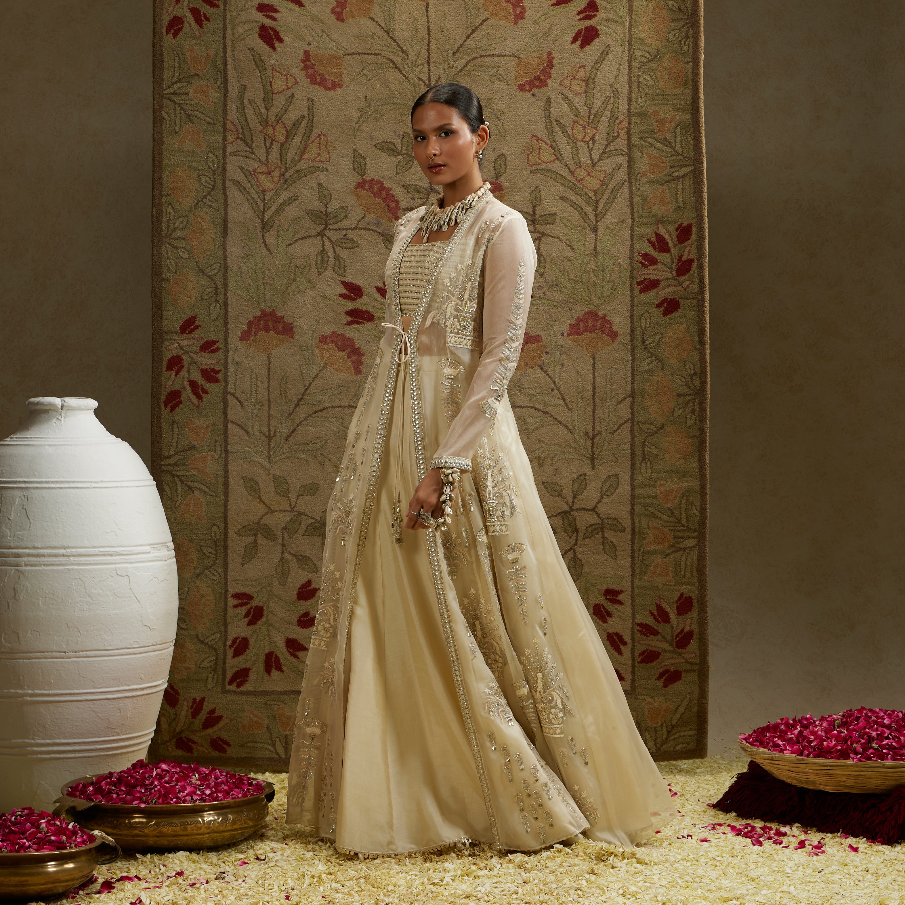 MEHEK: MAGNOLIA ORGANZA EMBELLISHED JACKET PAIRED WITH METAL BUSTIER AND LEHENGA