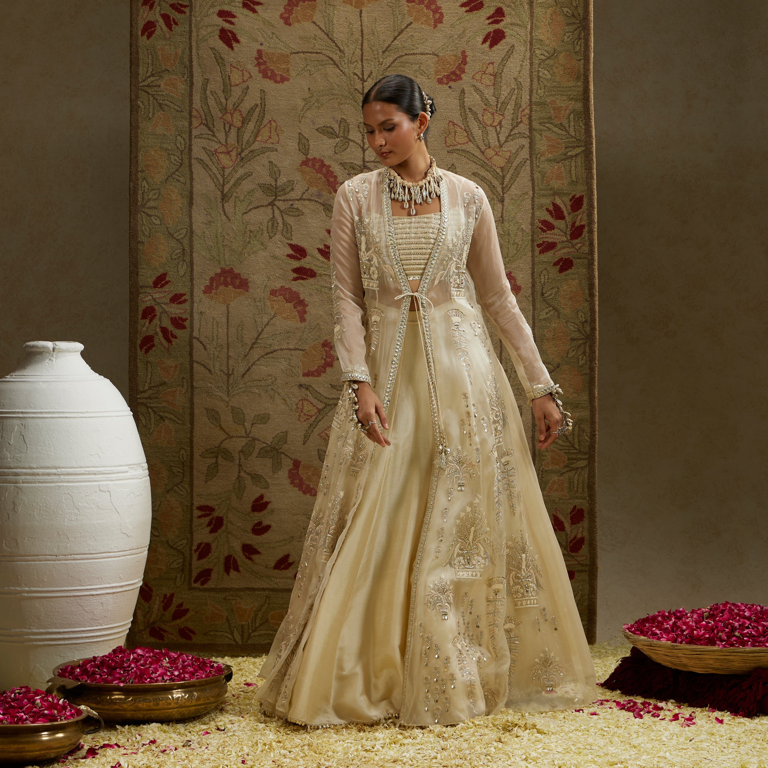 MEHEK: MAGNOLIA ORGANZA EMBELLISHED JACKET PAIRED WITH METAL BUSTIER AND LEHENGA