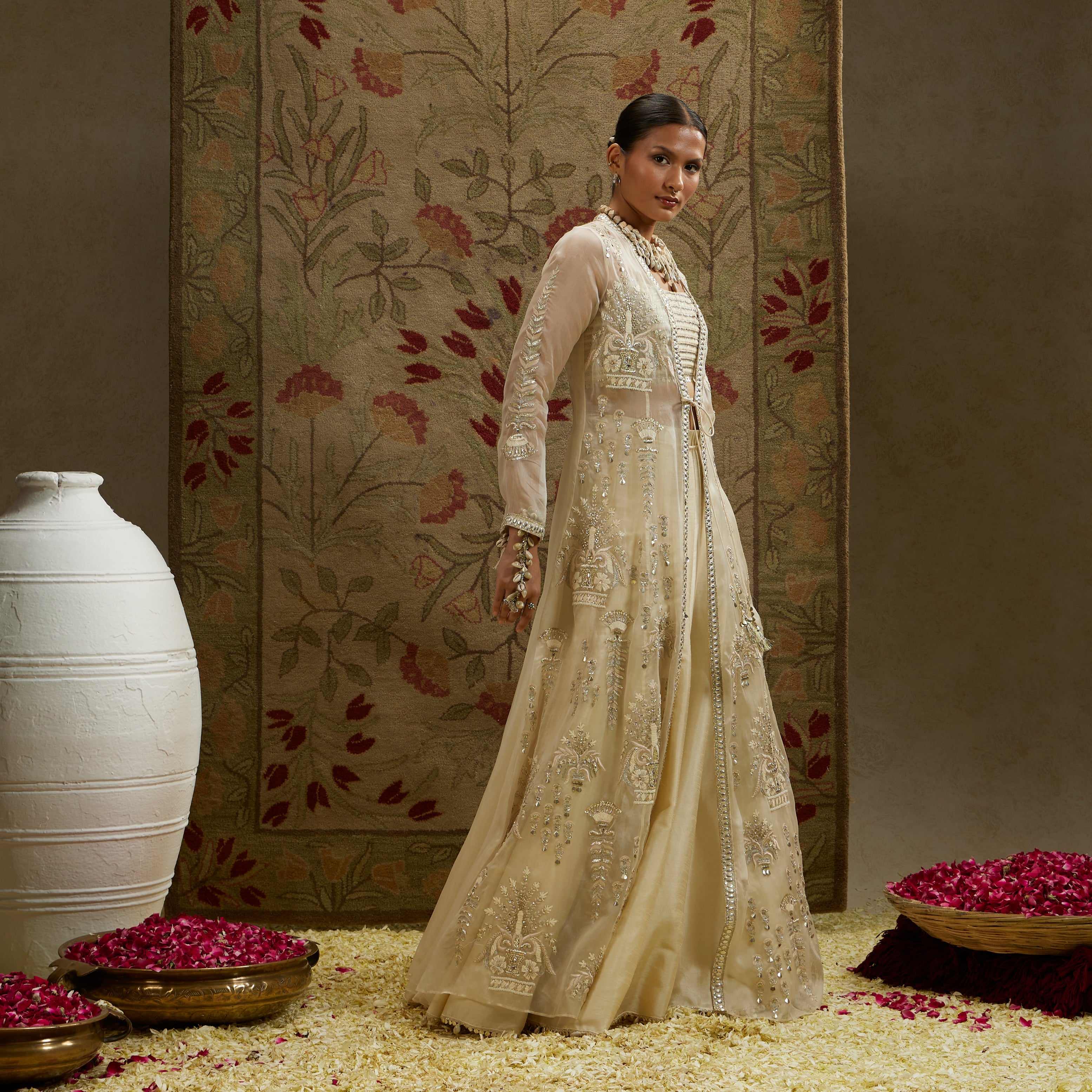 MEHEK: MAGNOLIA ORGANZA EMBELLISHED JACKET PAIRED WITH METAL BUSTIER AND LEHENGA