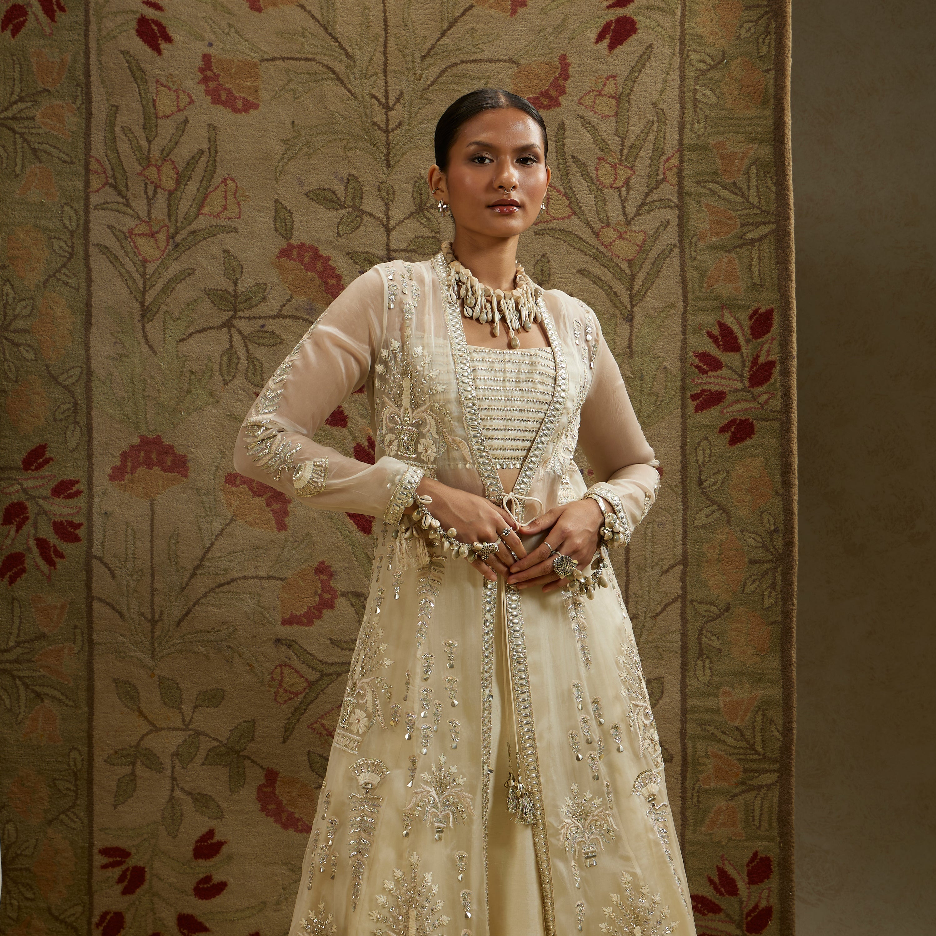 MEHEK: MAGNOLIA ORGANZA EMBELLISHED JACKET PAIRED WITH METAL BUSTIER AND LEHENGA