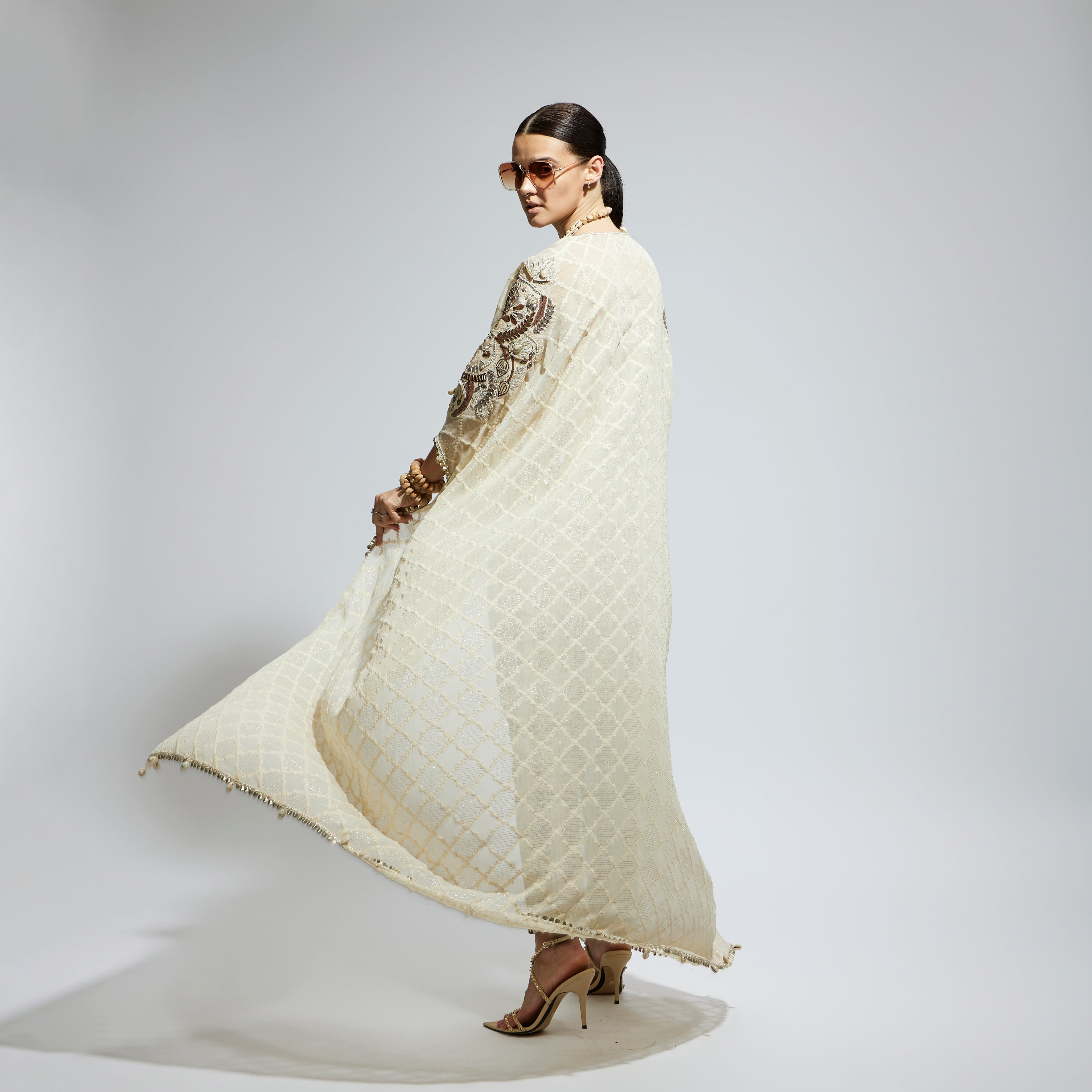 IVORY AZTEC EMBELLISHED CAPE PAIRED WITH HEAVILY EMBELLISHED BUSTIER AND PANTS: SAMSARA