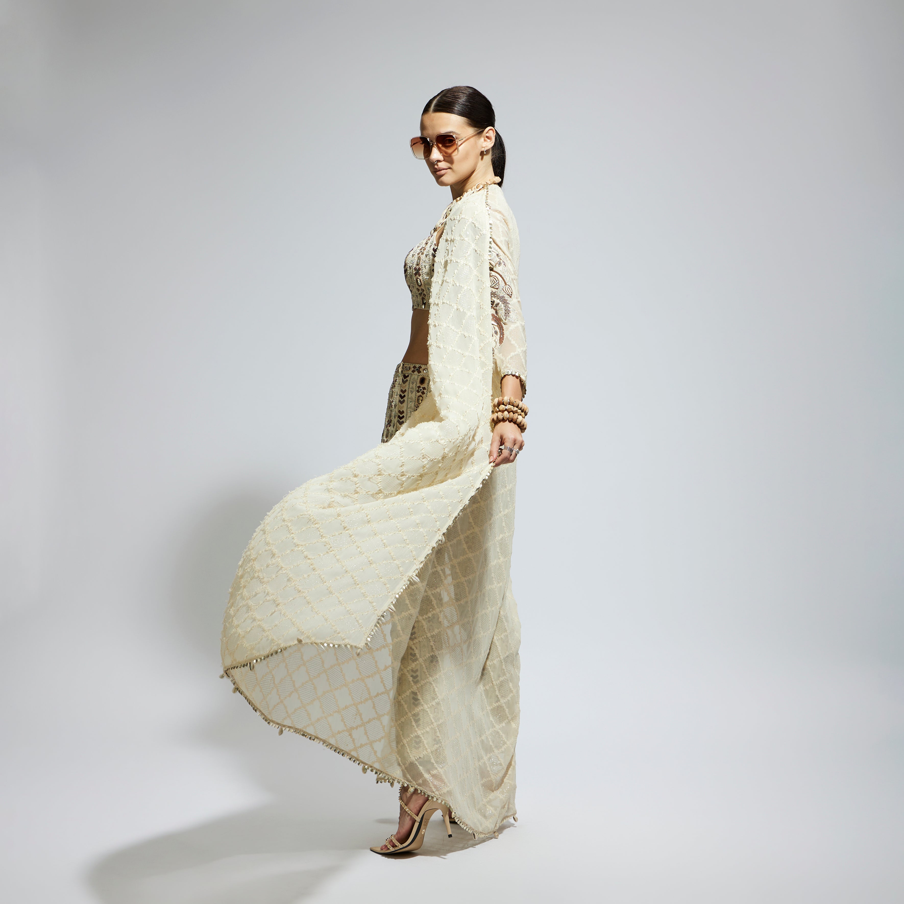 IVORY AZTEC EMBELLISHED CAPE PAIRED WITH HEAVILY EMBELLISHED BUSTIER AND PANTS: SAMSARA