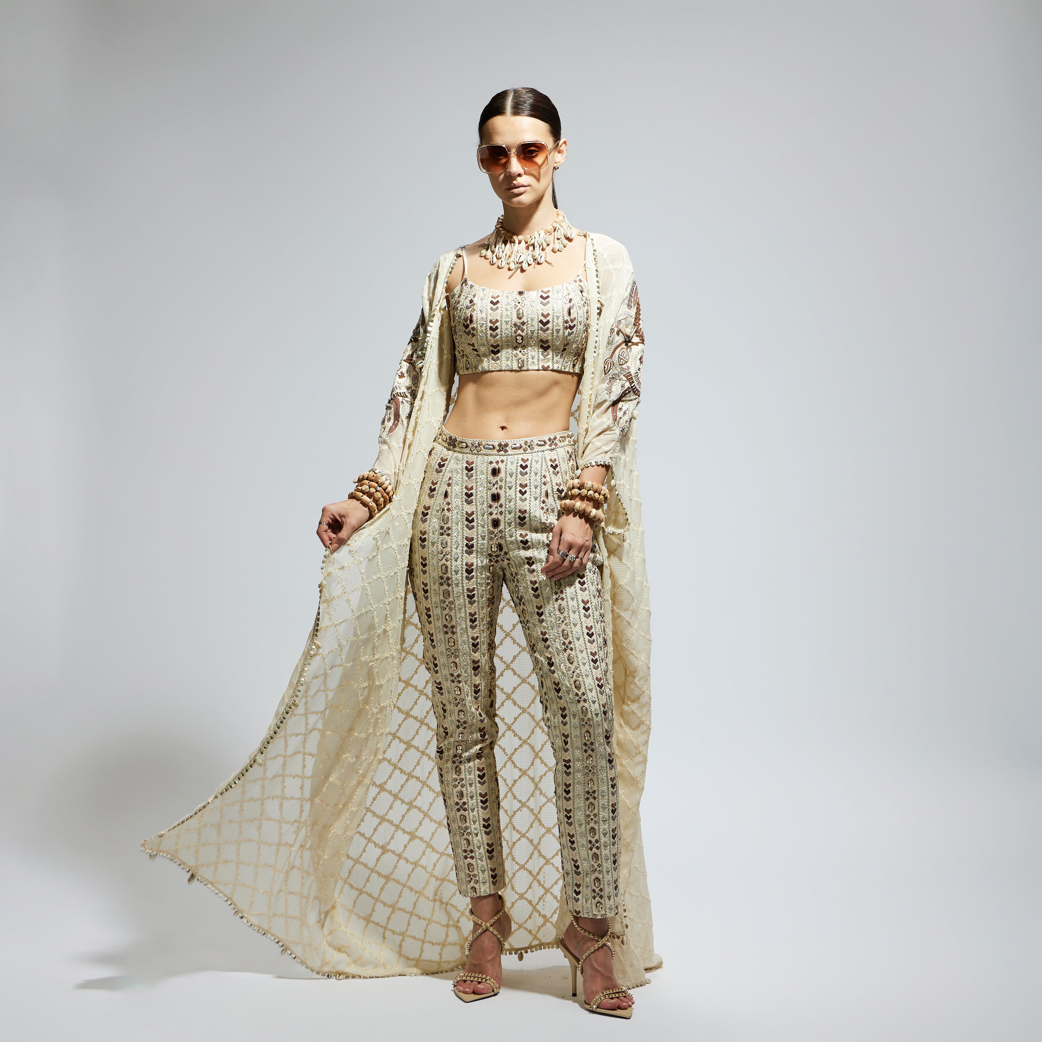 IVORY AZTEC EMBELLISHED CAPE PAIRED WITH HEAVILY EMBELLISHED BUSTIER AND PANTS