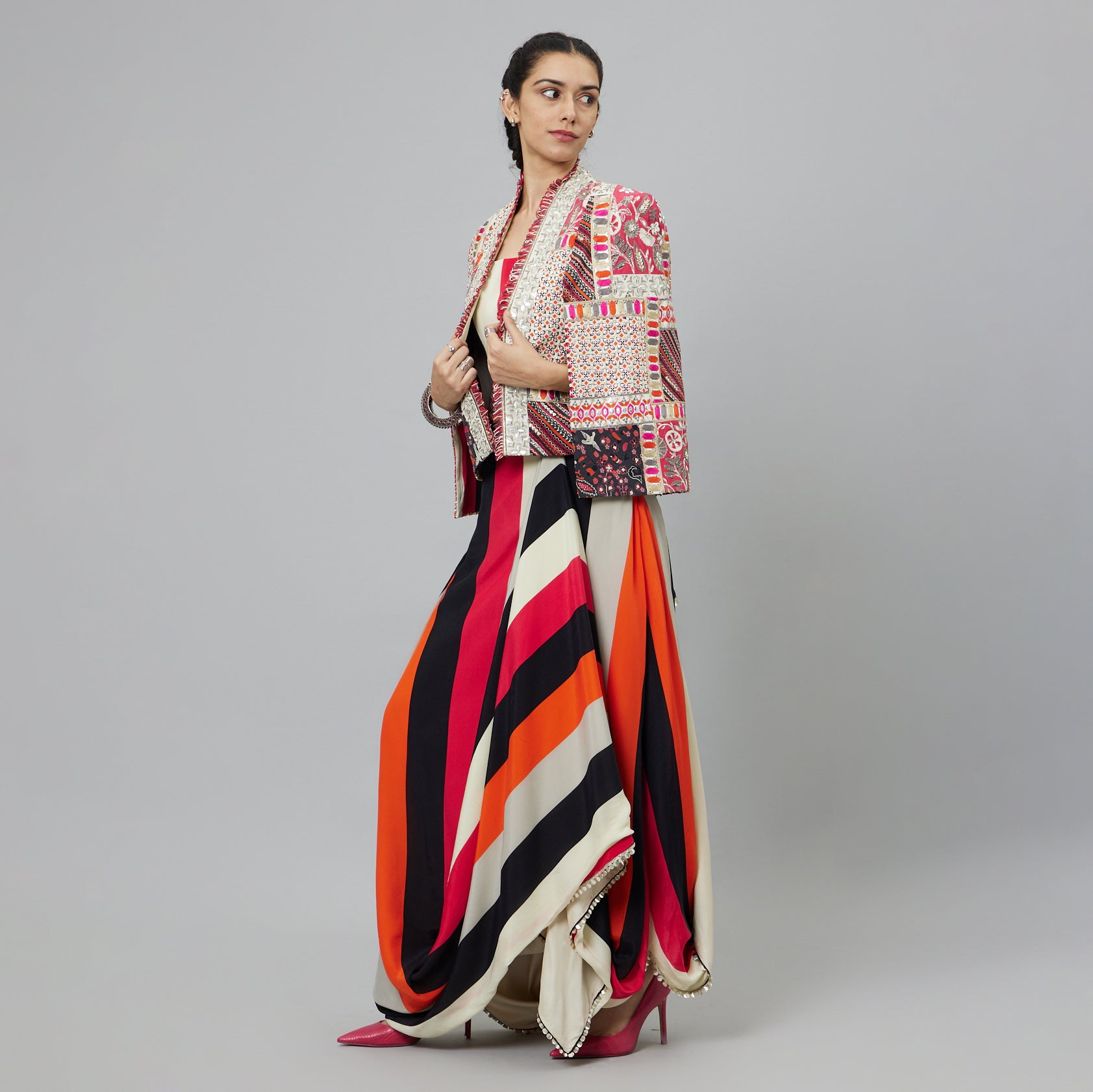 SHAHAR STRIPE PRINT NUSHRAT DRAPED SKIRT AND BUSTIER TEAMED WITH A SIGNATURE STRUCTURED JACKET