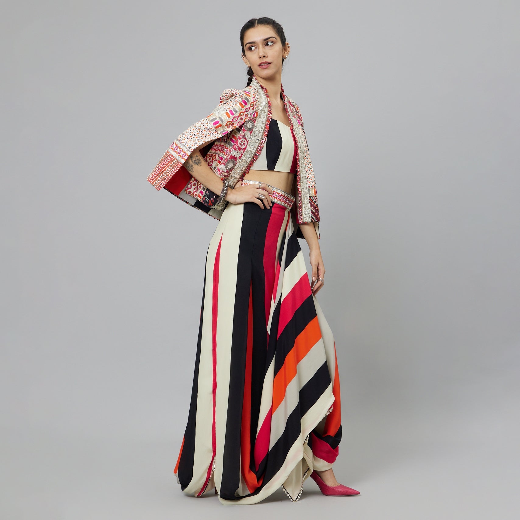 SHAHAR STRIPE PRINT NUSHRAT DRAPED SKIRT AND BUSTIER TEAMED WITH A SIGNATURE STRUCTURED JACKET