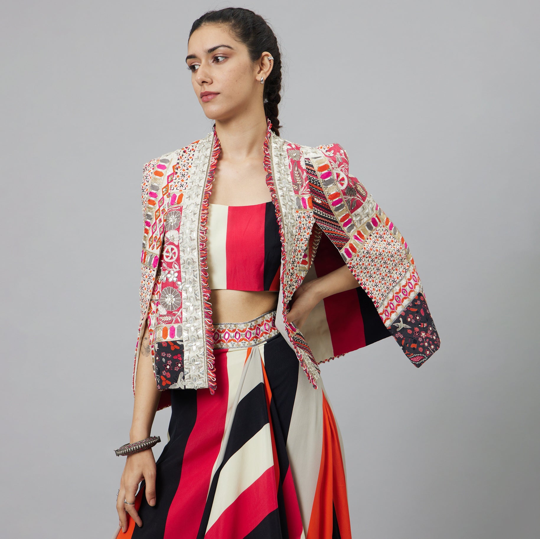 SHAHAR STRIPE PRINT NUSHRAT DRAPED SKIRT AND BUSTIER TEAMED WITH A SIGNATURE STRUCTURED JACKET