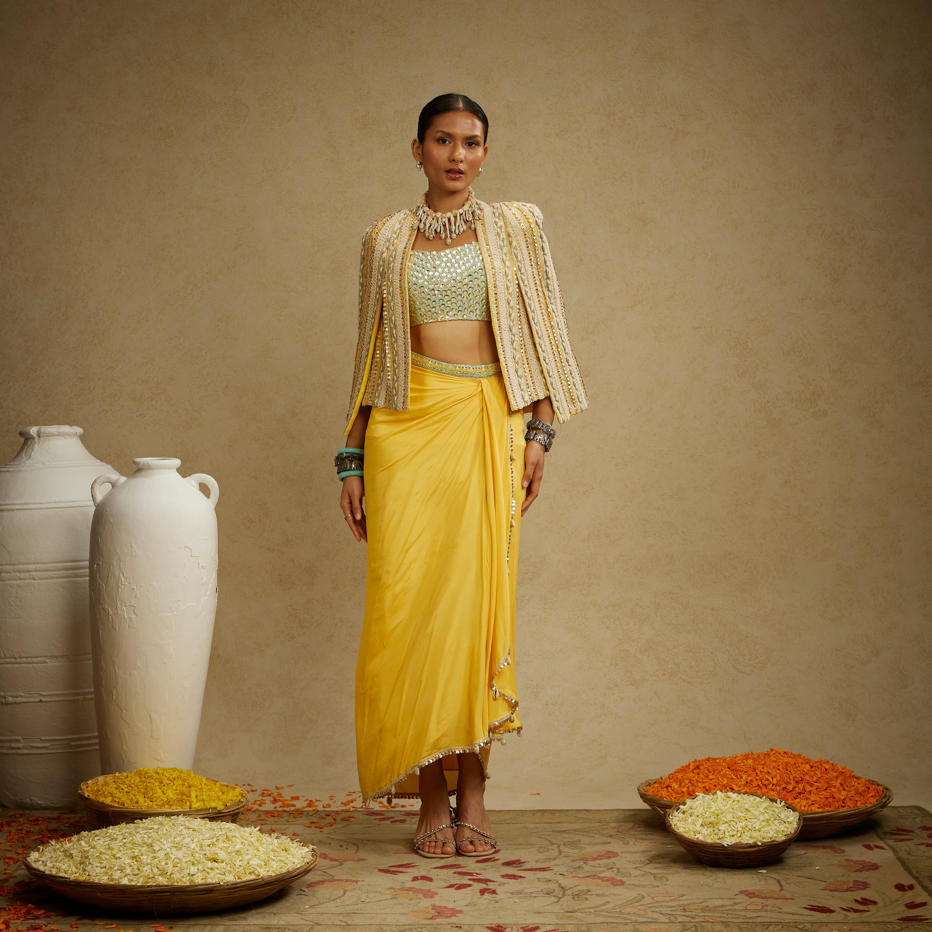 DANDELION EMBELLISHED JACKET PAIRED WITH EMBELLISHED BUSTIER AND HIGH SLIT SKIRT