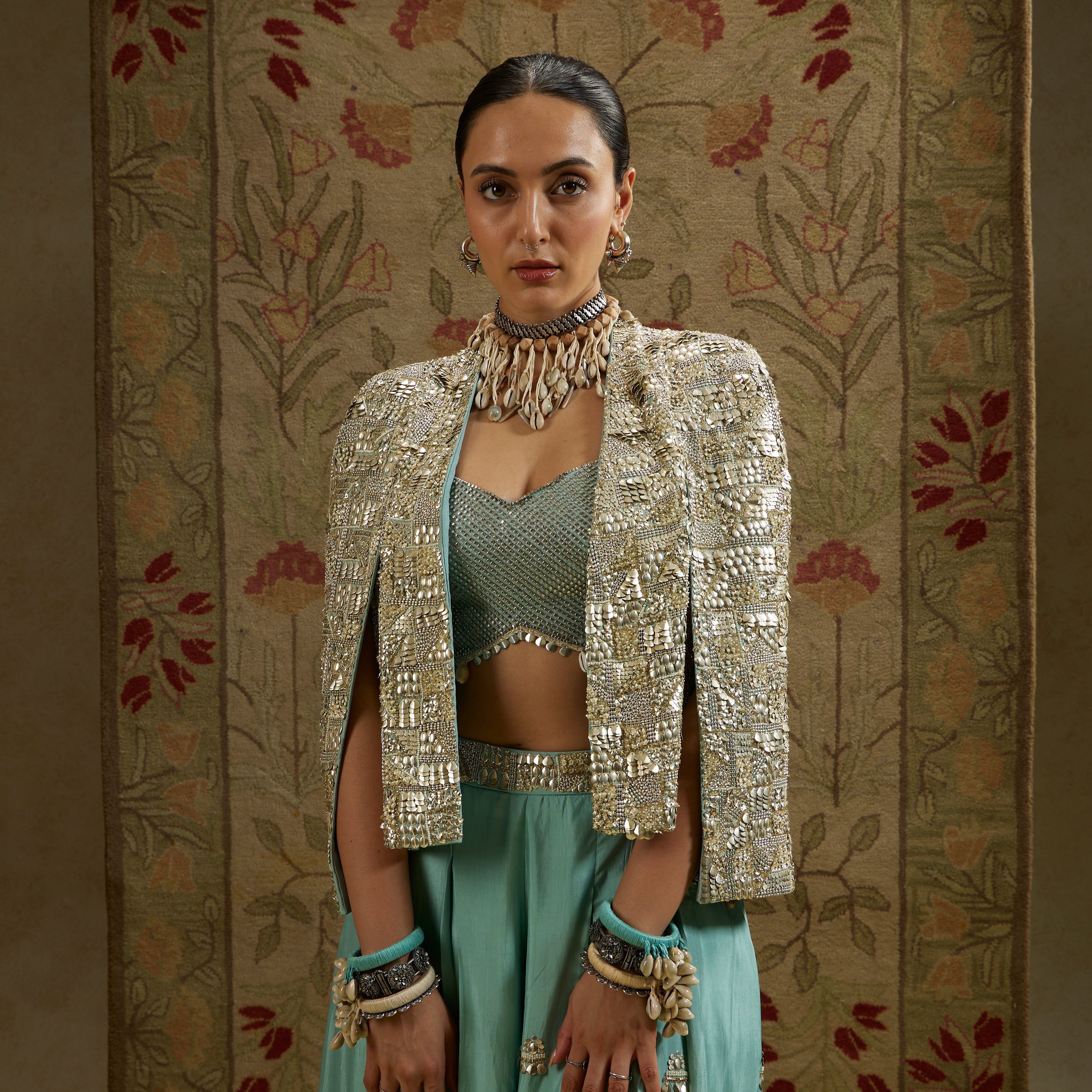 METALLIC NOOR JACKET PAIRED WITH METALLIC BUSTIER AND EMBELLISHED PLEATED PANTS