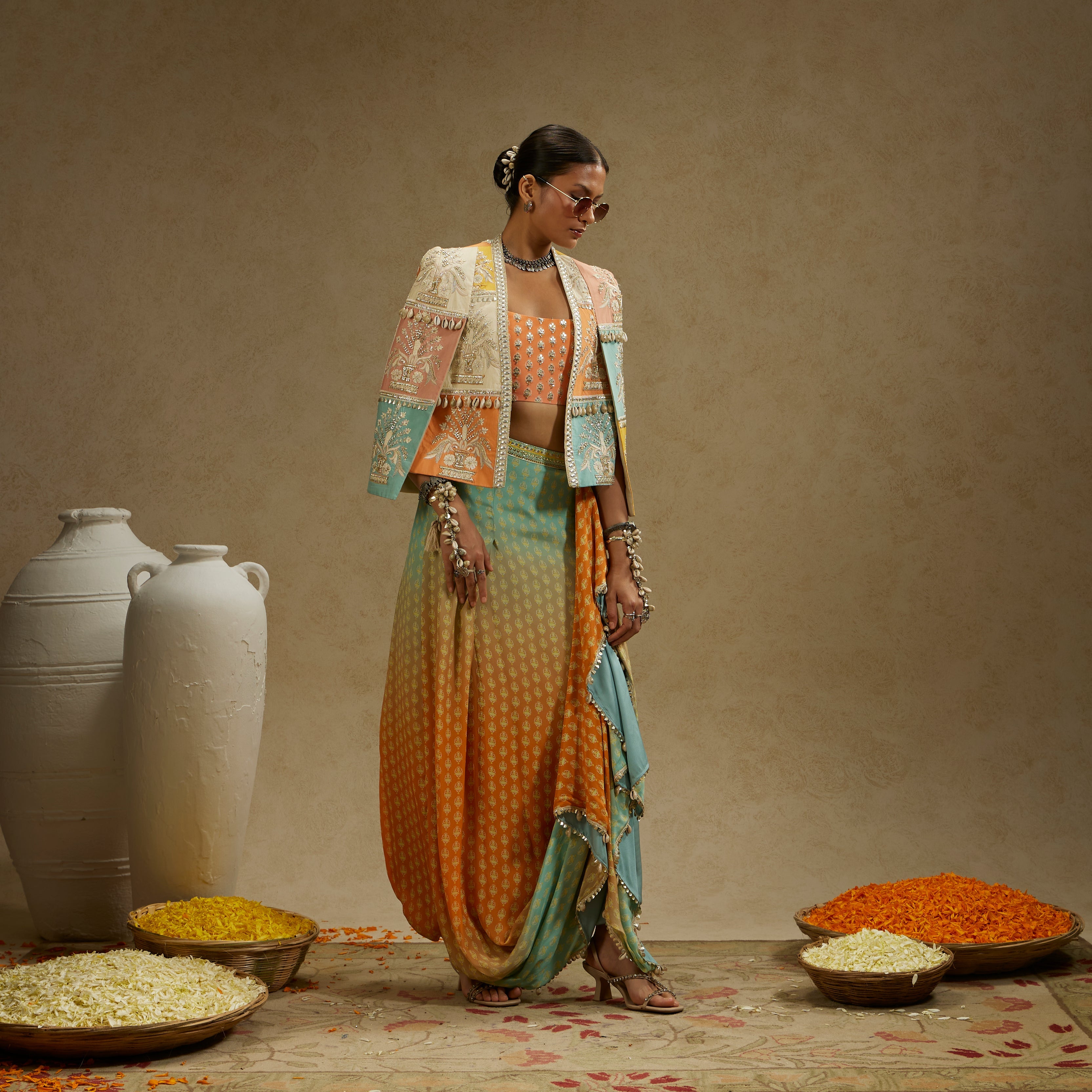 MEHEK: COLOUR BLOCKED PATCHWORK CAPE JACKET PAIRED WITH AN EMBELLISHED BUSTIER AND AN OMBRE PRINTED DRAPED SKIRT