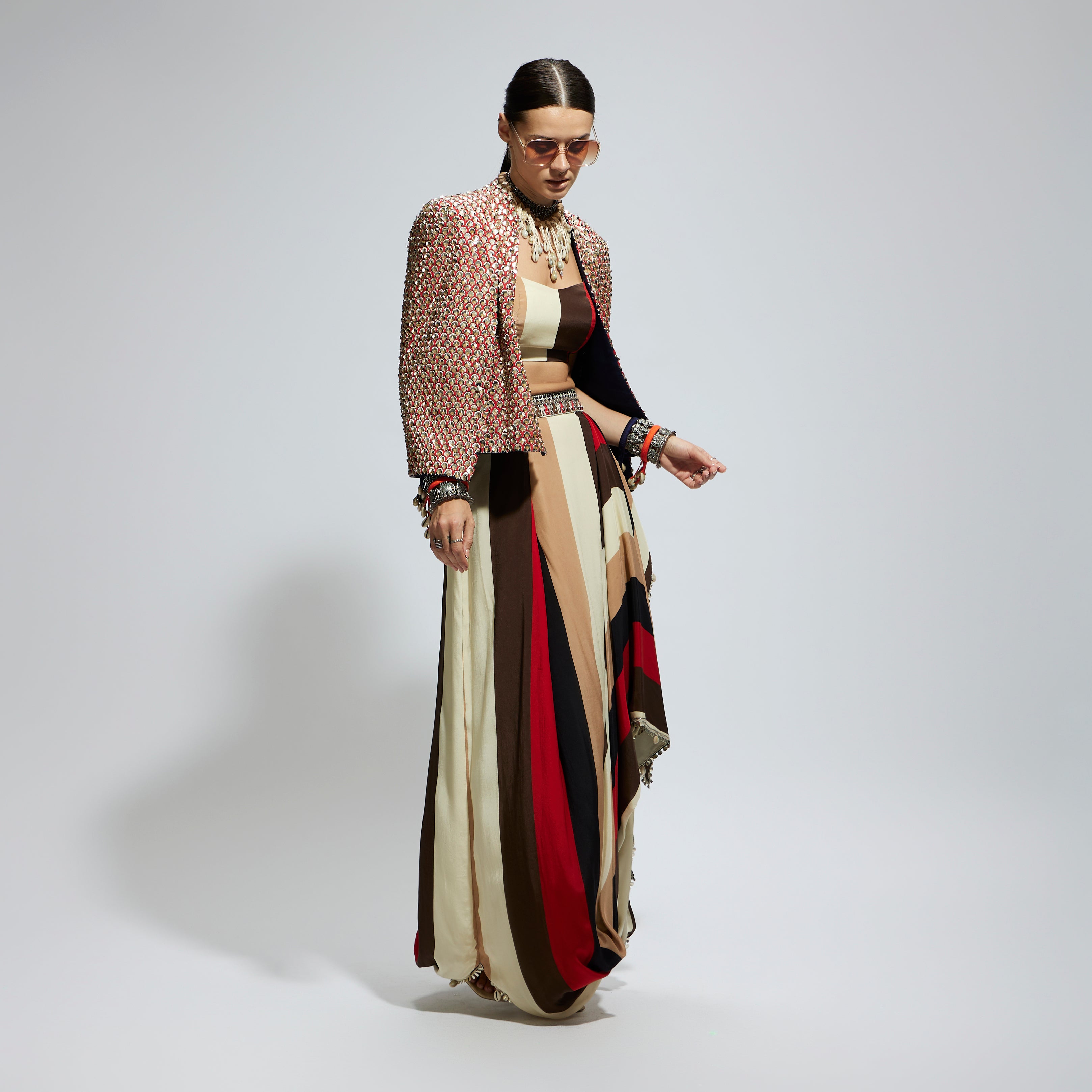 METALLIC EMBELLISHED CAPE JACKET PAIRED WITH STRIPE BUSTIER AND STRIPE DRAPE SKIRT