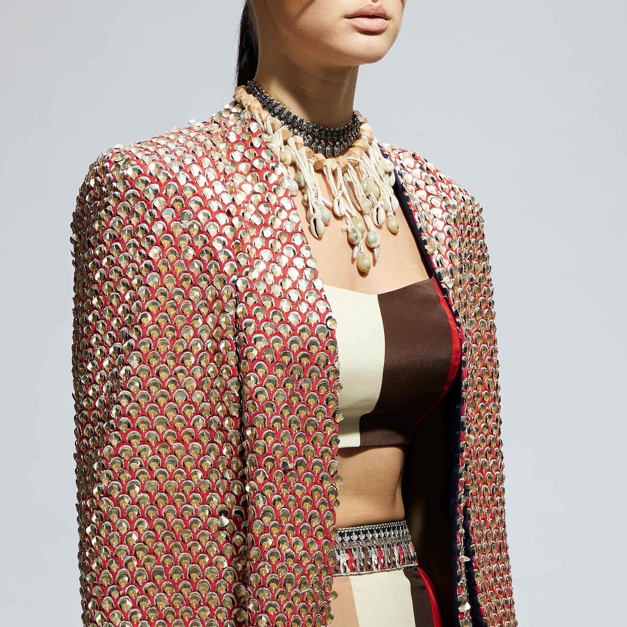 METALLIC EMBELLISHED CAPE JACKET PAIRED WITH STRIPE BUSTIER AND STRIPE DRAPE SKIRT