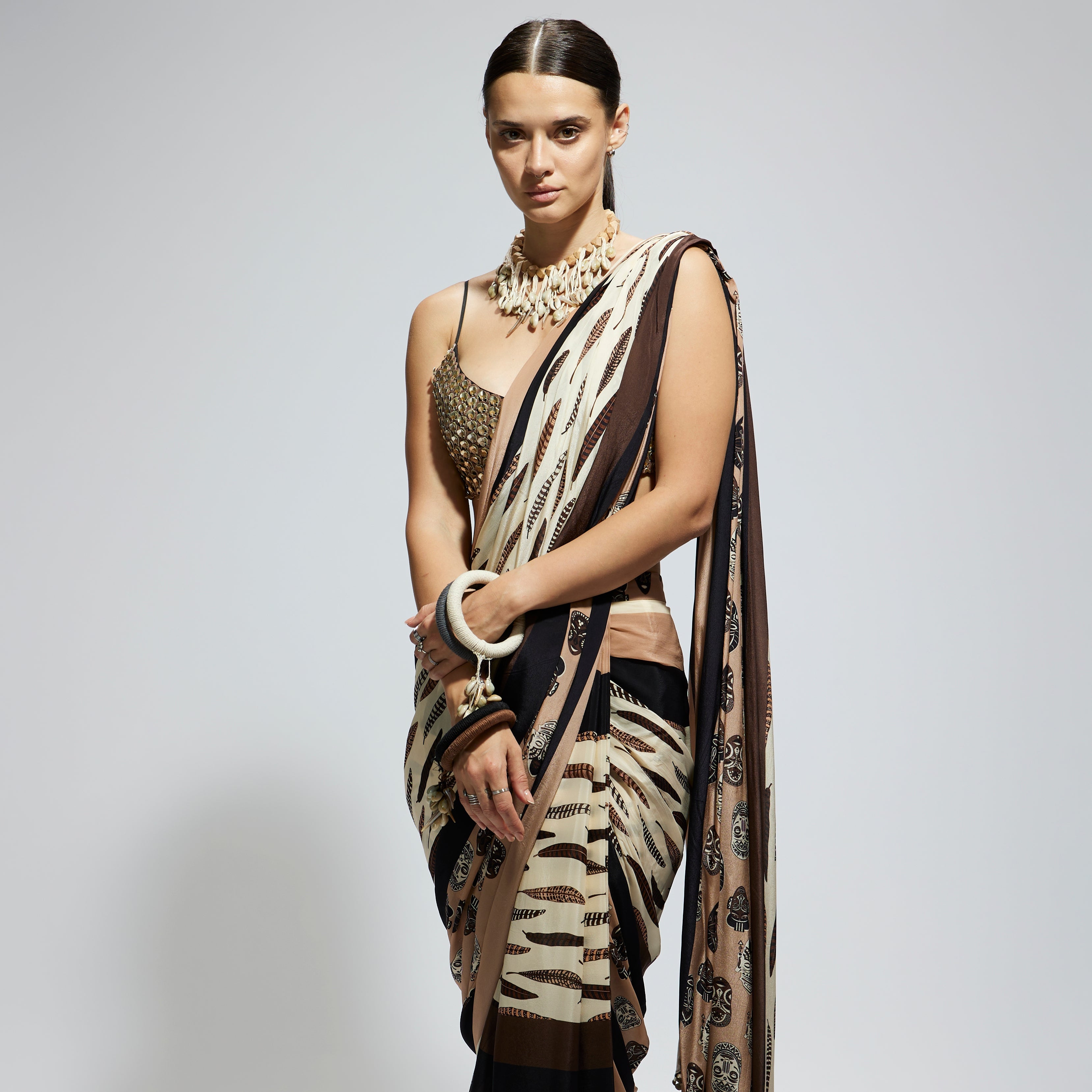 MASK AND FEATHER PRINT CASCADE SAREE PAIRED WITH METALLIC SCALLOP BUSTIER