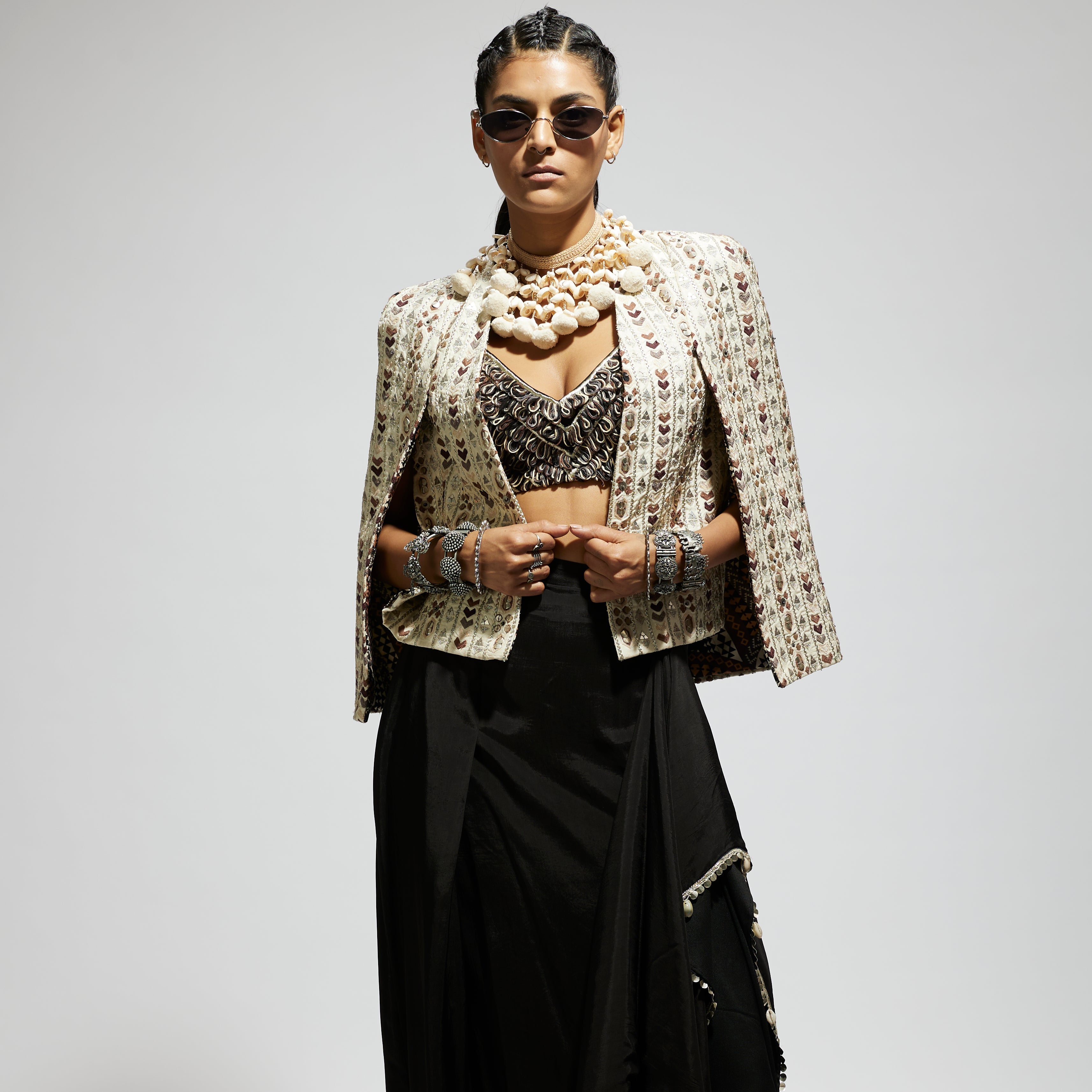 IVORY EMBELLISHED CAPE JACKET PAIRED WITH TEXTURED BUSTIER AND DRAPE SKIRT