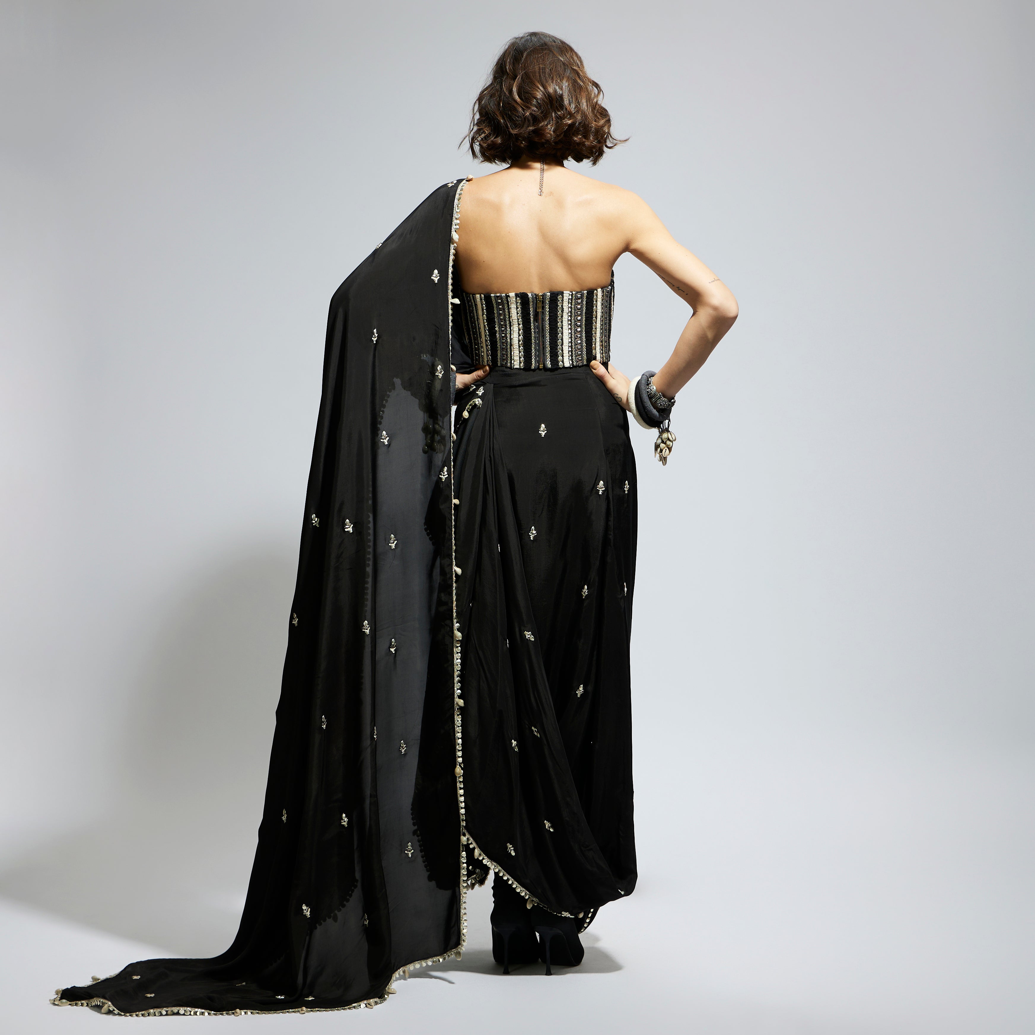 BLACK THREADWORK CORSET PAIRED WITH EMBELLISHED SAREE DRAPED SKIRT: SAMSARA