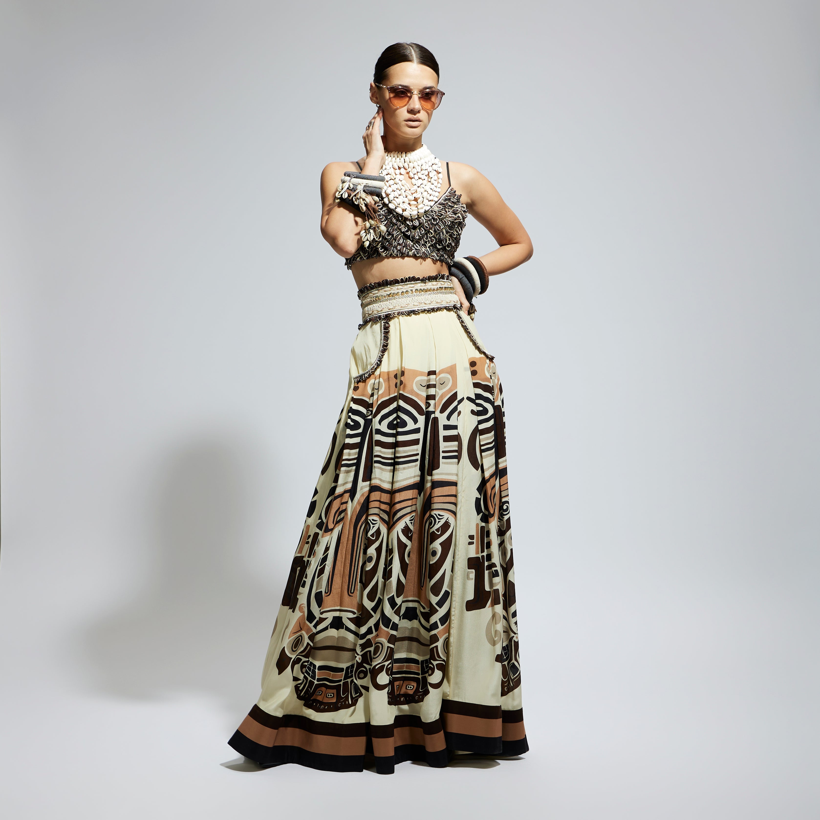 IVORY MASK PRINTED BOX PLEATED SKIRT WITH POCKETS TEAMED WITH A TEXTURED BUSTIER