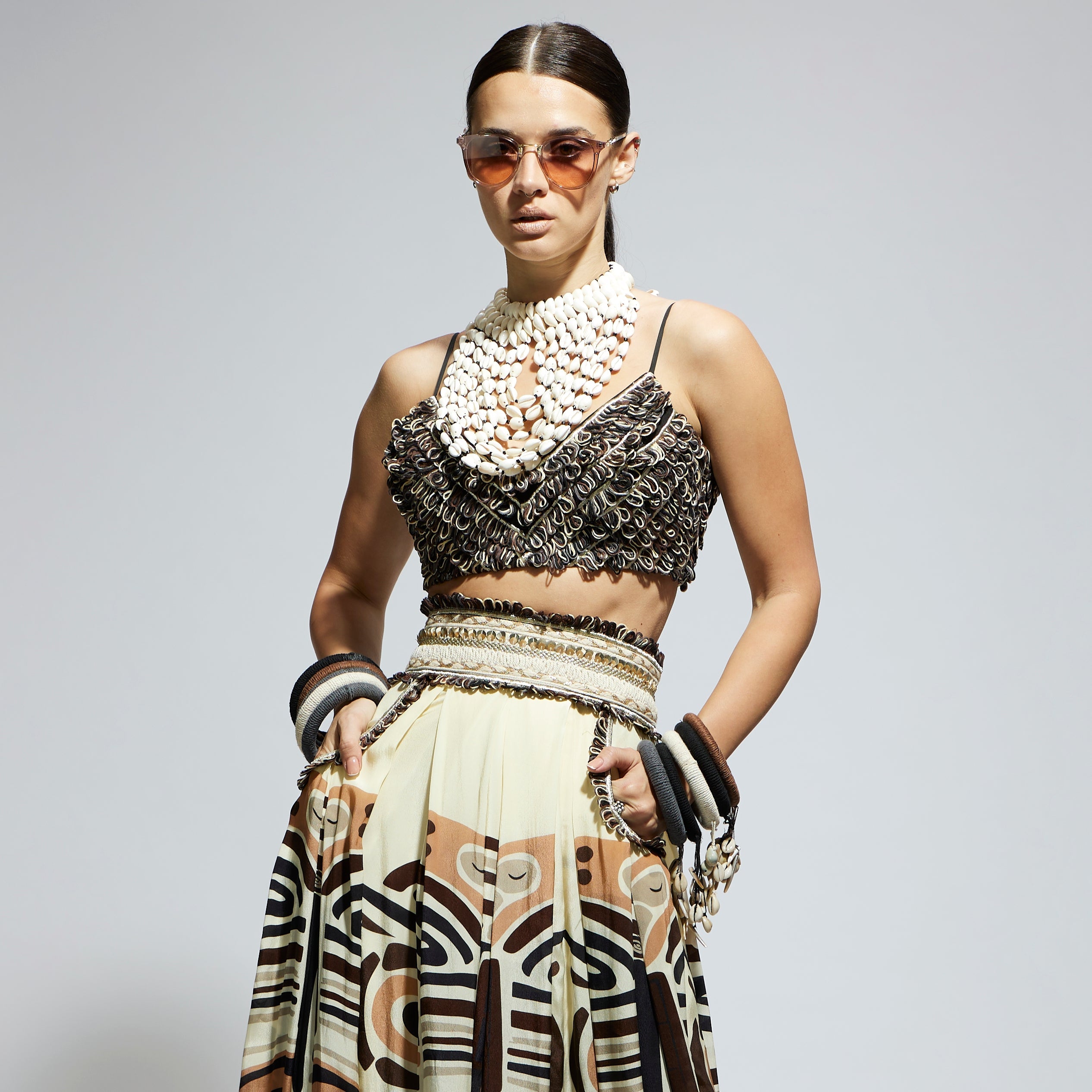 IVORY MASK PRINTED BOX PLEATED SKIRT WITH POCKETS TEAMED WITH A TEXTURED BUSTIER