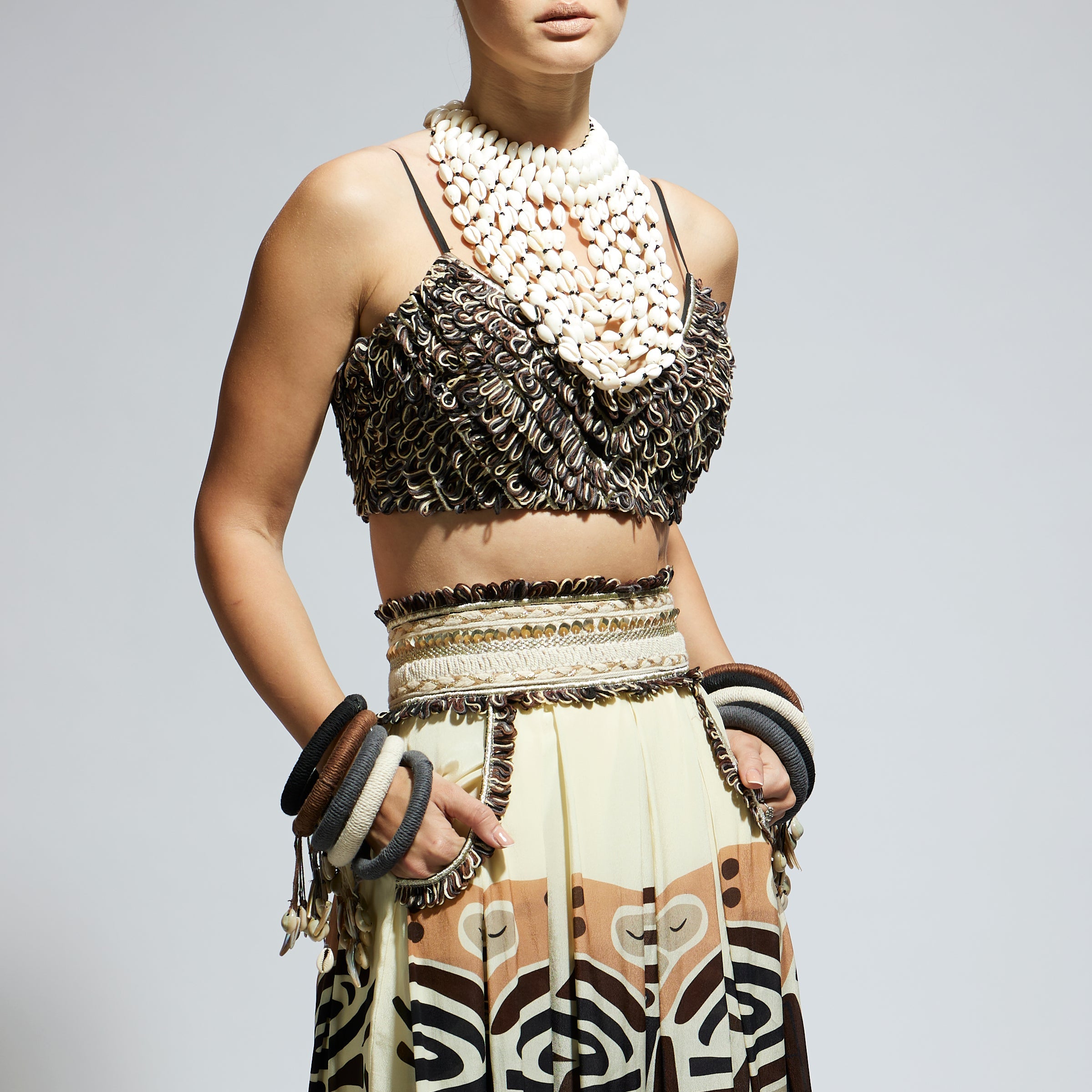 IVORY MASK PRINTED BOX PLEATED SKIRT WITH POCKETS TEAMED WITH A TEXTURED BUSTIER