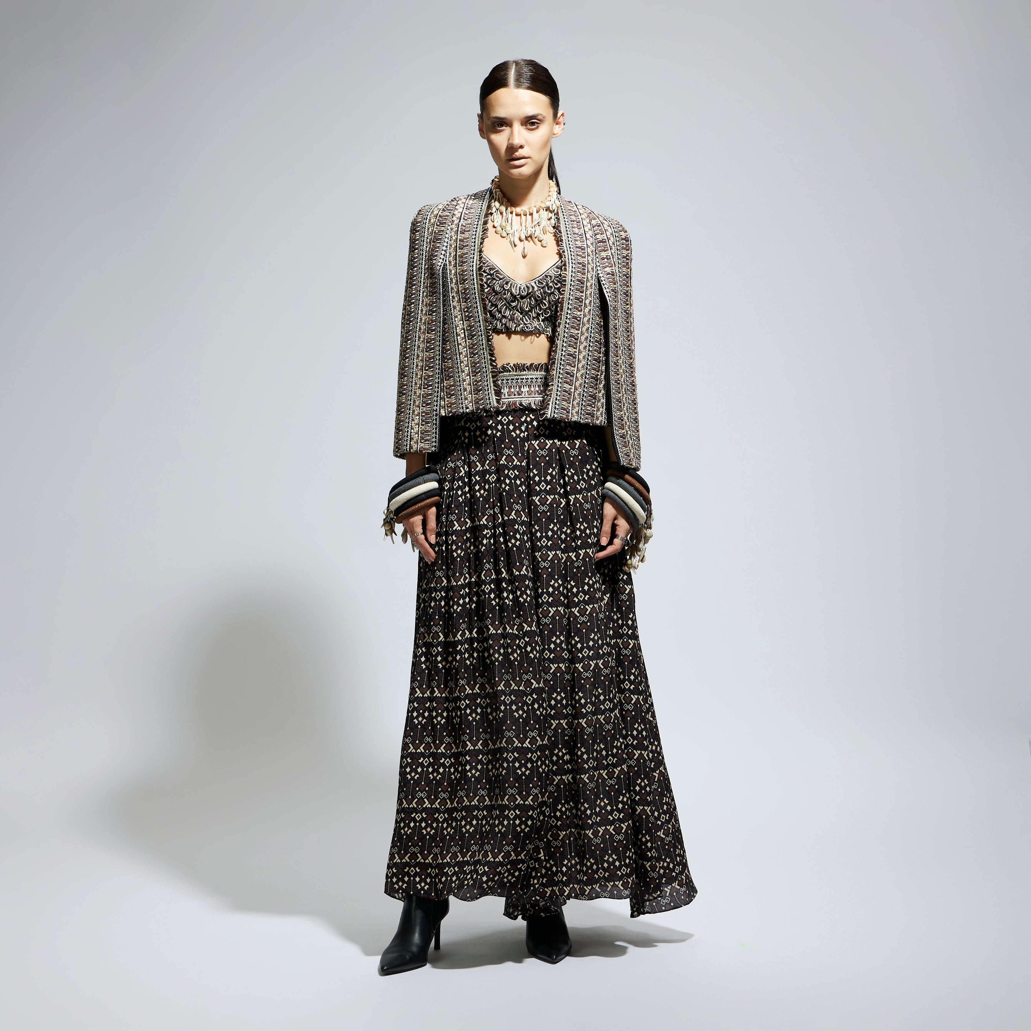 BROWN THREADWORK CAPE JACKET PAIRED WITH TEXTURED BUSTIER AND FLARED PANTS