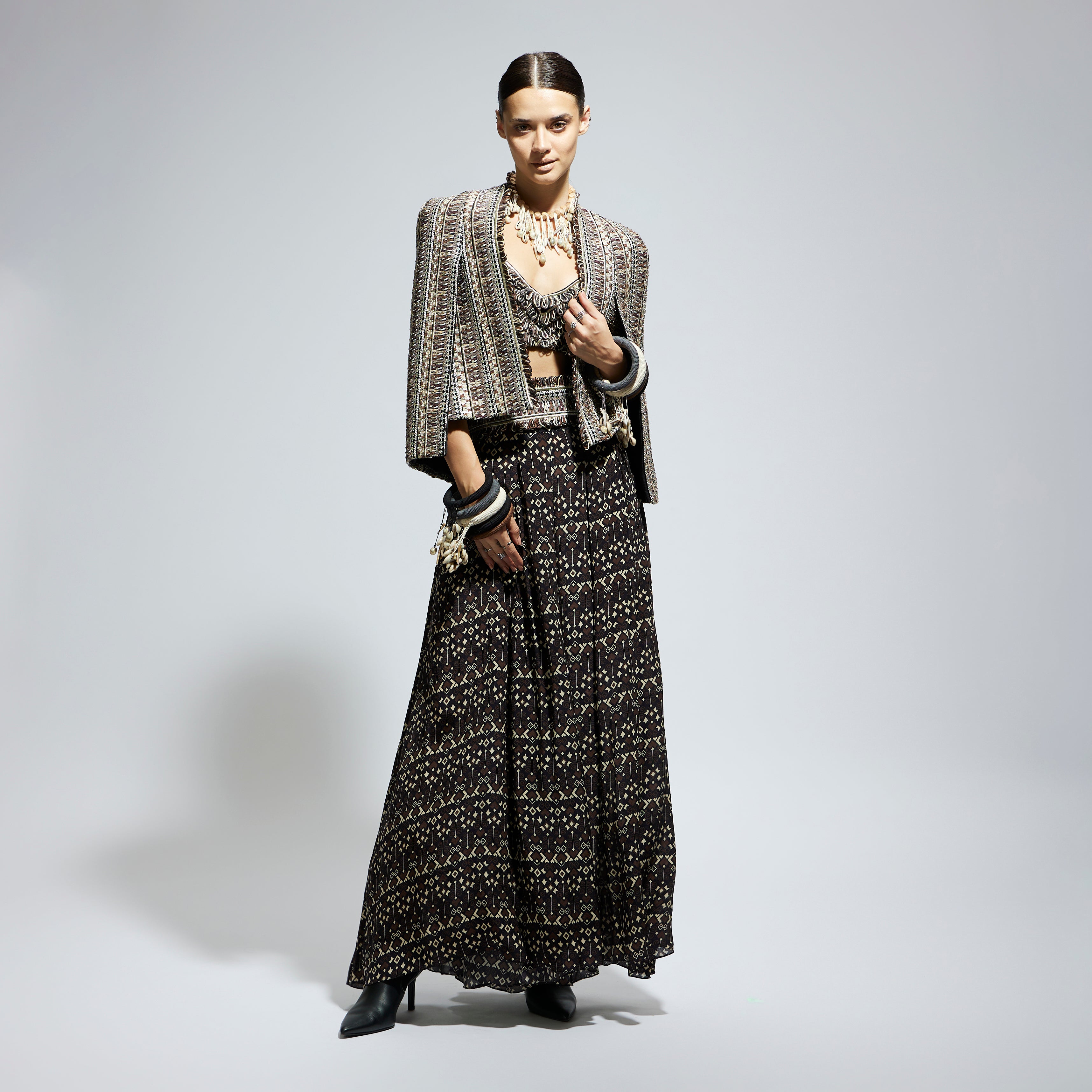 BROWN THREADWORK CAPE JACKET PAIRED WITH TEXTURED BUSTIER AND FLARED PANTS