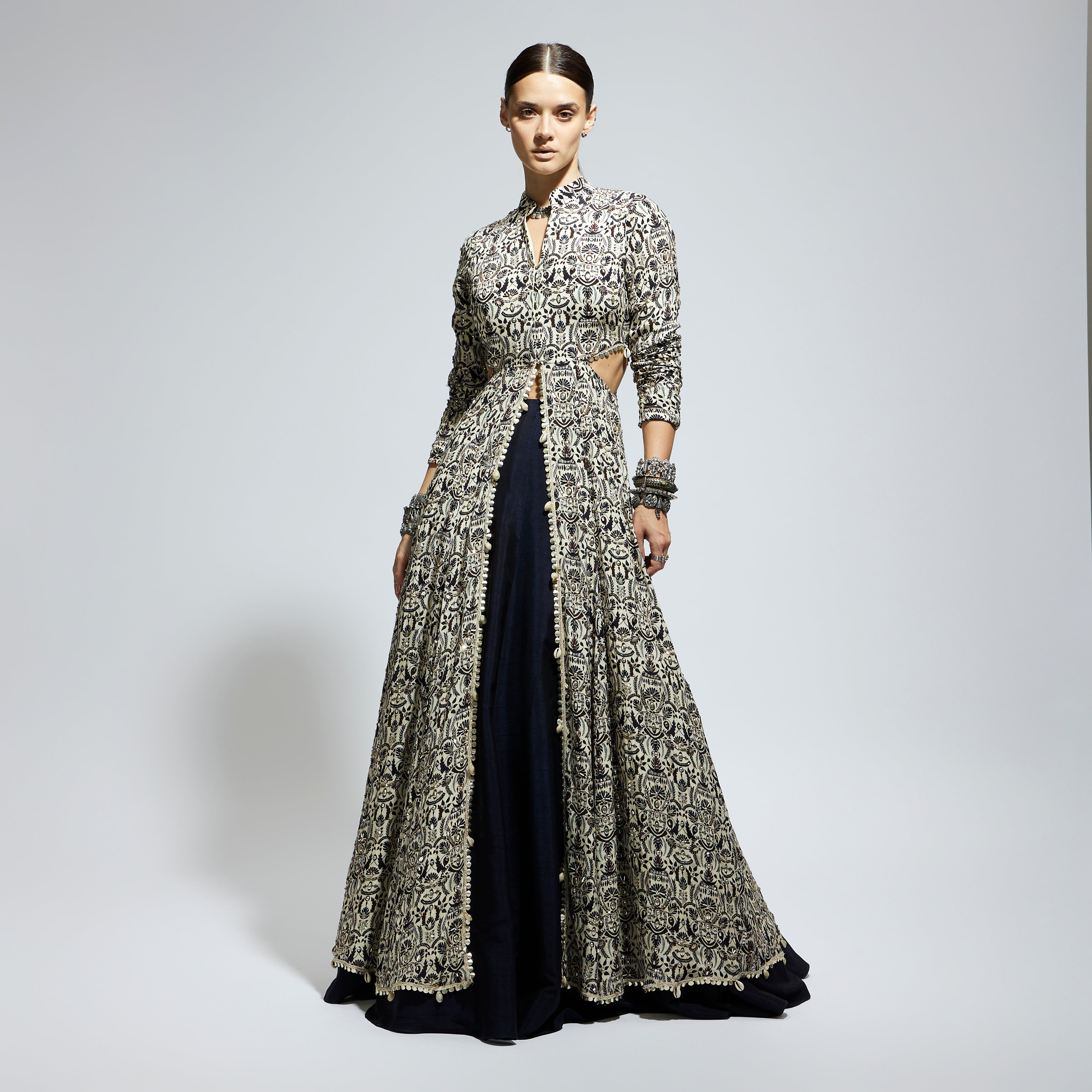 WHITE HEAVILY EMBELLISHED WAIST CUT OUT JACKET PAIRED A MIDNIGHT BLUE LEHENGA