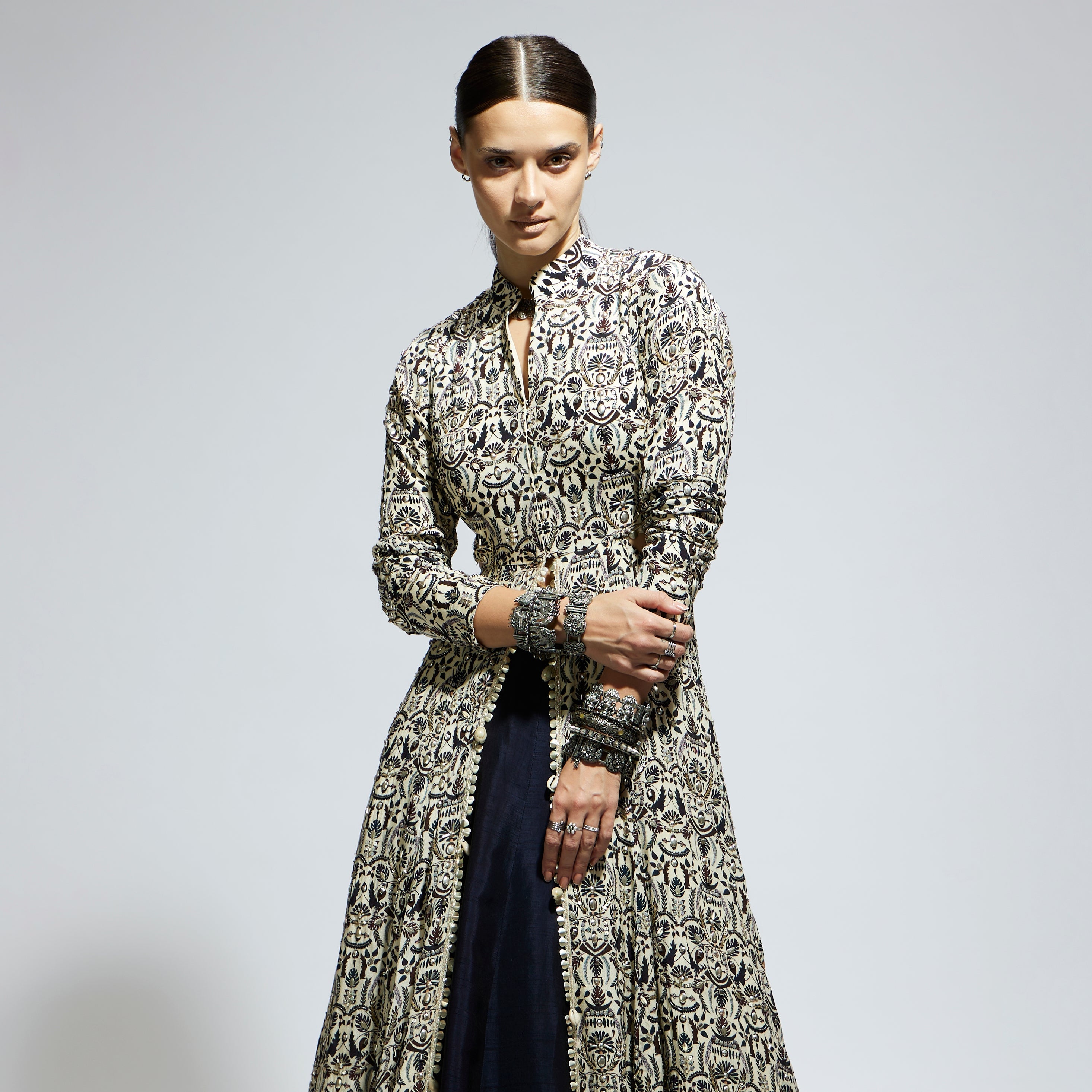 WHITE HEAVILY EMBELLISHED WAIST CUT OUT JACKET PAIRED A MIDNIGHT BLUE LEHENGA