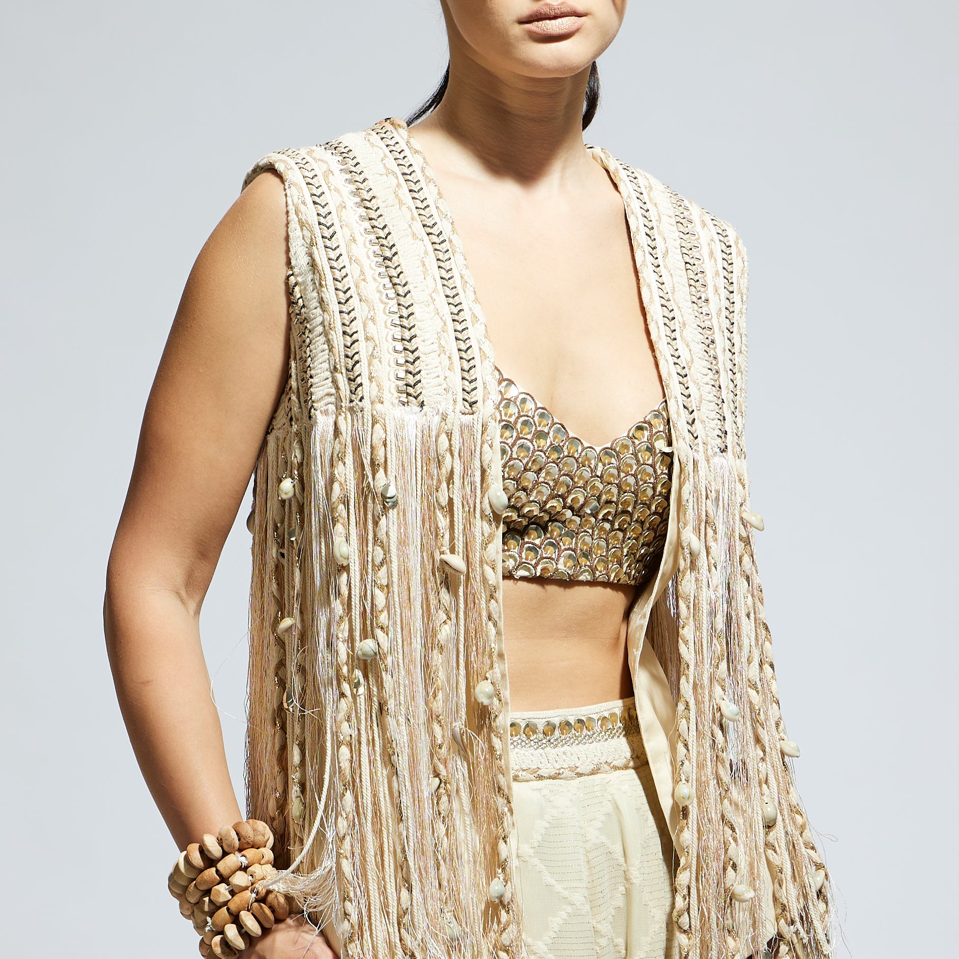 IVORY THREADWORK FRINGE JACKET PAIRED WTH SCALLOP METALLIC BUSTIER AND IVORY AZTEC FLARED PANTS