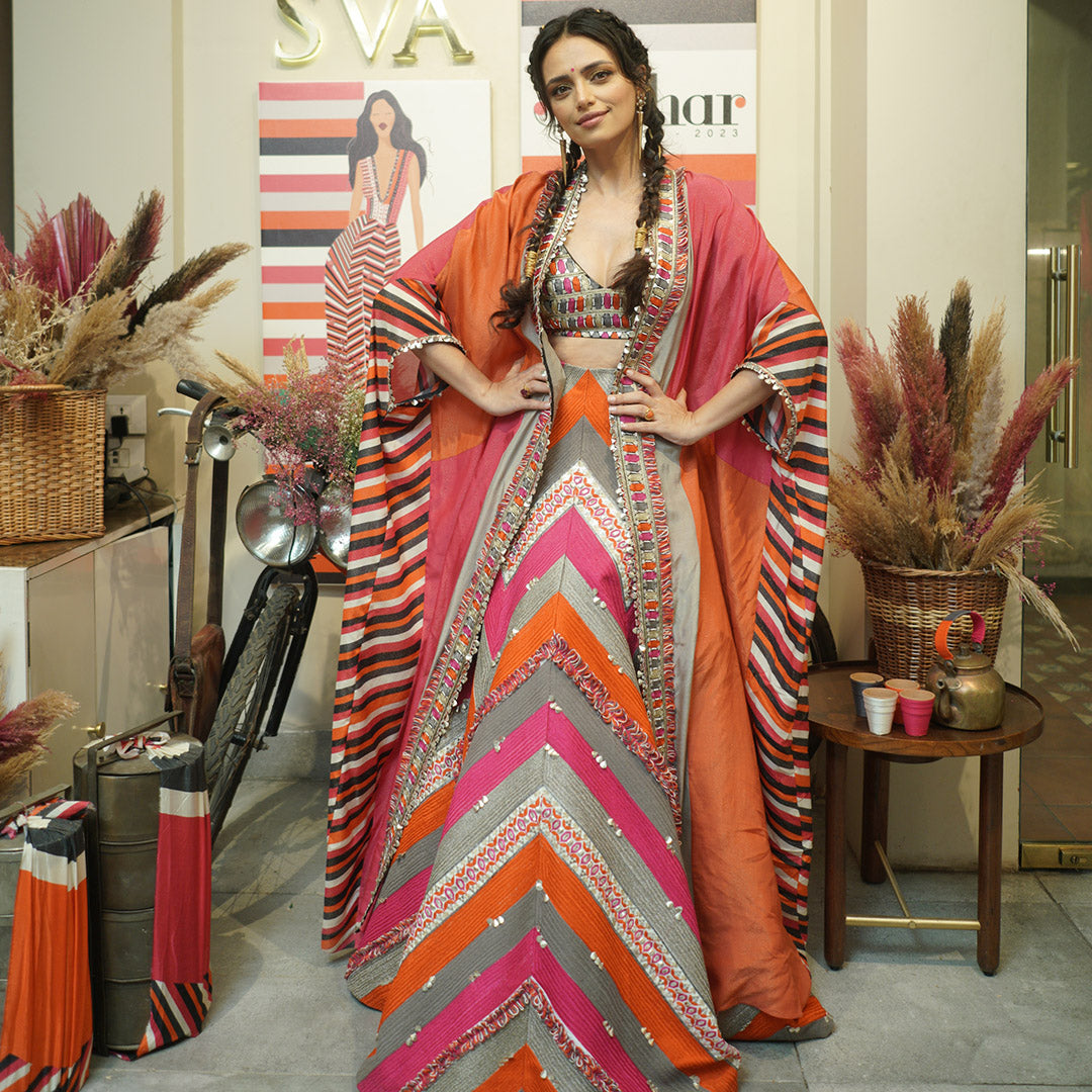 THREADWORK EMBELLISHED CHEVRON LEHENGA TEAMED WITH A COLOUR BLOCKED EMBELLISHED CAPE AND BUSTIER