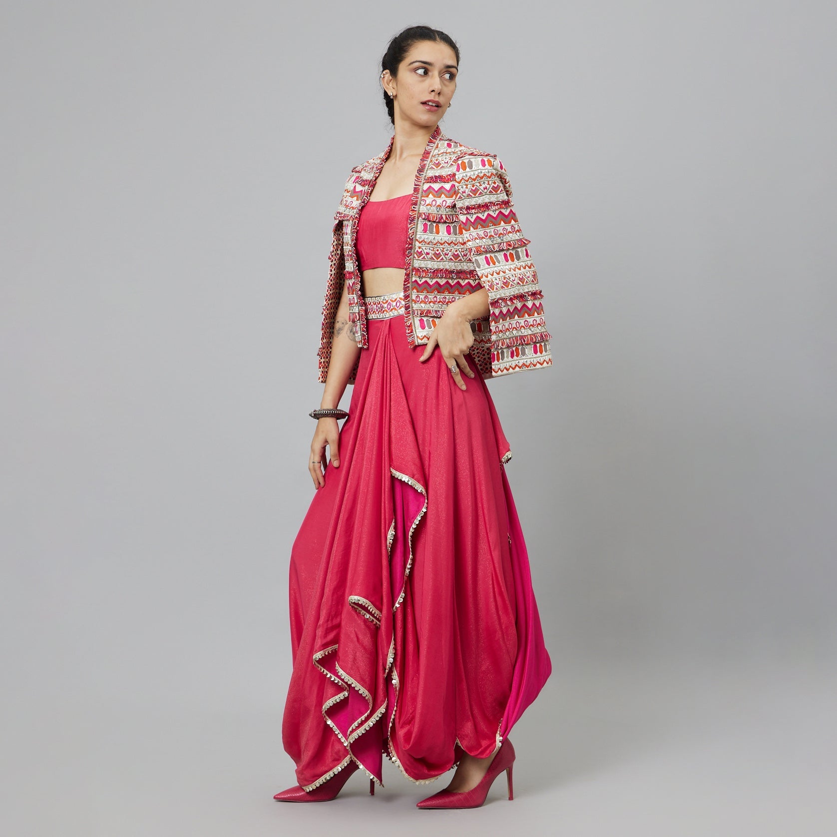 PINK NUSHRAT DRAPED SKIRT AND BUSTIER TEAMED WITH A SIGNATURE STRUCTURED JACKET