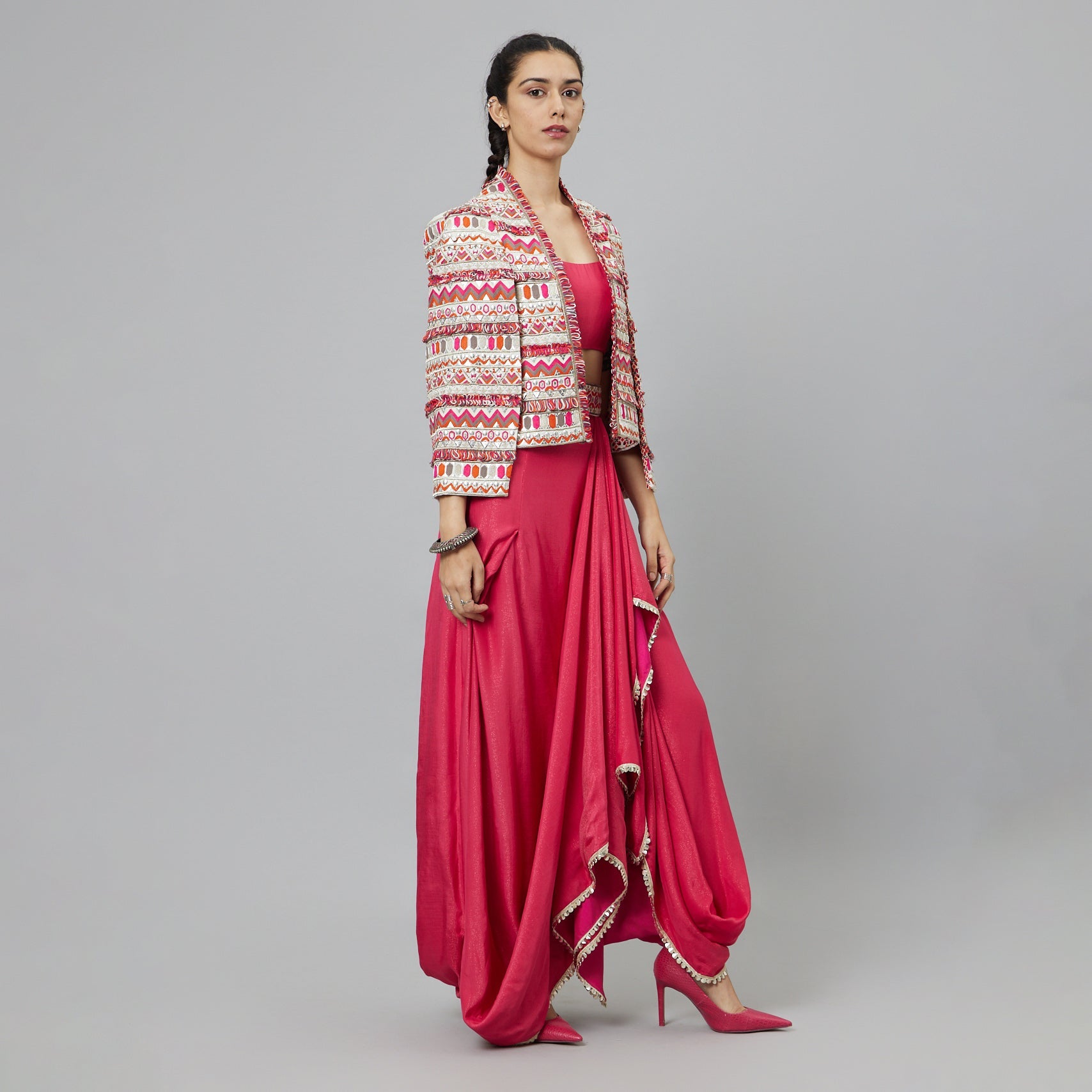 PINK NUSHRAT DRAPED SKIRT AND BUSTIER TEAMED WITH A SIGNATURE STRUCTURED JACKET