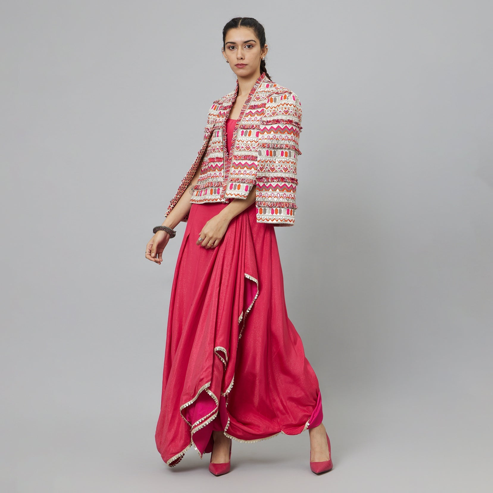 PINK NUSHRAT DRAPED SKIRT AND BUSTIER TEAMED WITH A SIGNATURE STRUCTURED JACKET