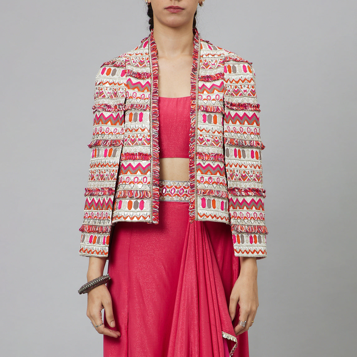 PINK NUSHRAT DRAPED SKIRT AND BUSTIER TEAMED WITH A SIGNATURE STRUCTURED JACKET