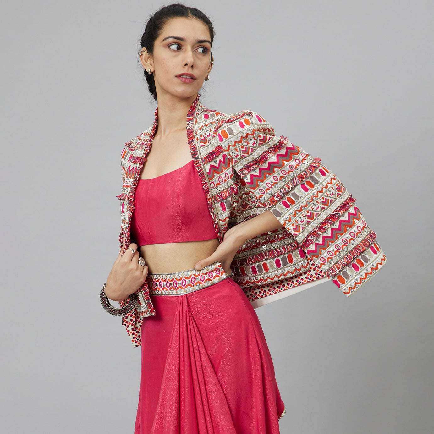 PINK NUSHRAT DRAPED SKIRT AND BUSTIER TEAMED WITH A SIGNATURE STRUCTURED JACKET