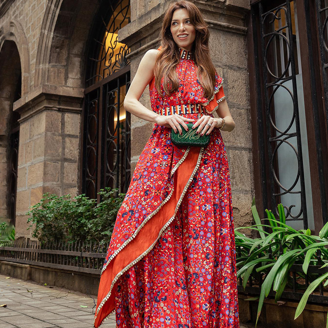 RED CROP TOP WITH ATTACHED DRAPE OF LEAF PRINT AND RED JAAL PRINT WITH BLUE SHARARA PANTS WITH EMB BELT