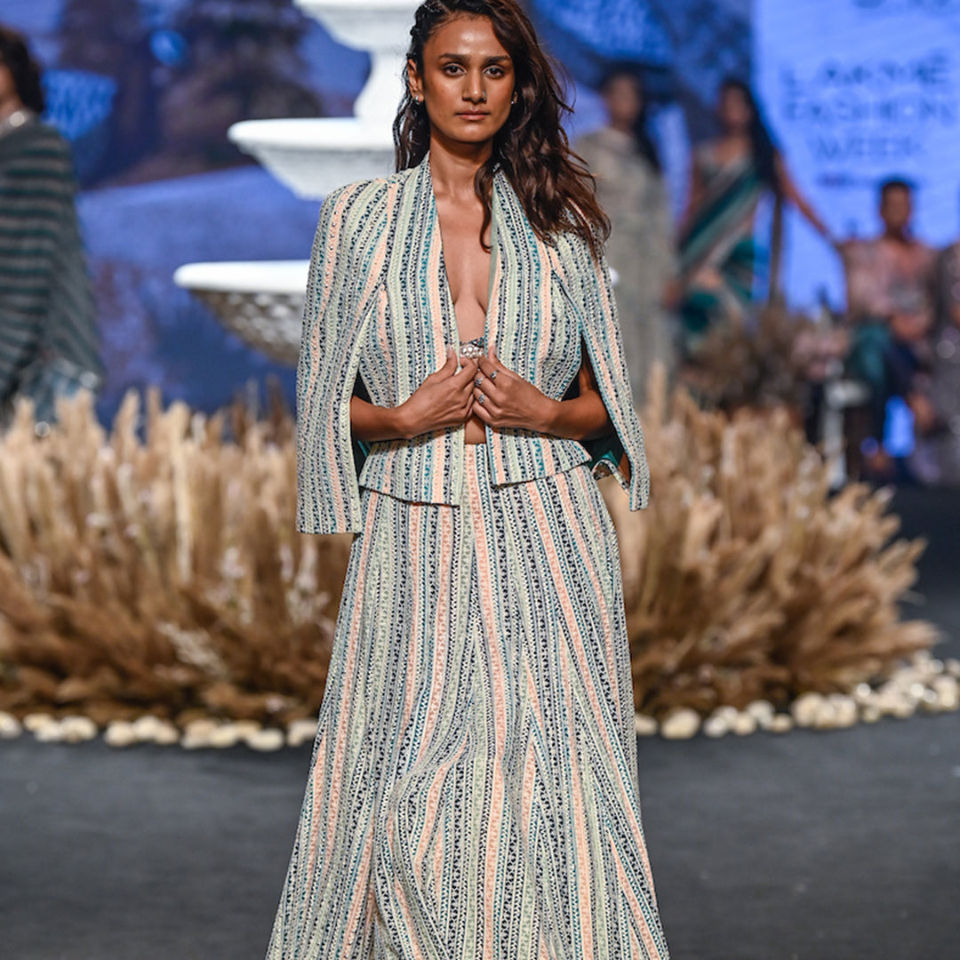 STRIPE PRINTED LUCKNOWI LEHNGA TEAMED WITH A PATCHWORK CORSET AND STRUCTURED CAPE JACKET