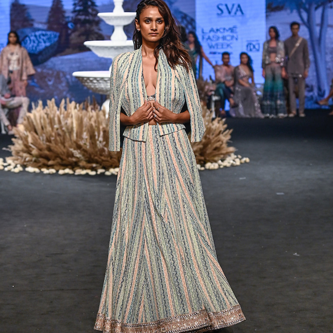 STRIPE PRINTED LUCKNOWI LEHNGA TEAMED WITH A PATCHWORK CORSET AND STRUCTURED CAPE JACKET