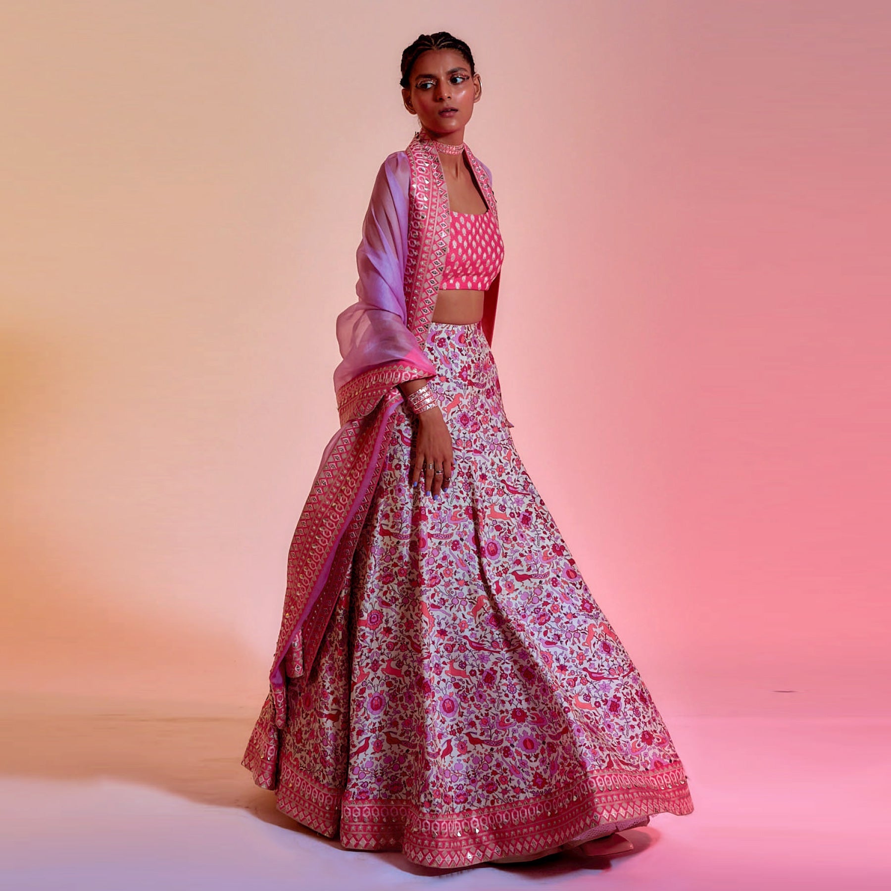 IVORY SAANJH FLORAL PRINT LEHENGA WITH CORAL EMBELLISHED BORDER AND BLOUSE TEAMED WITH A LILAC ORGANZA DUPATTA